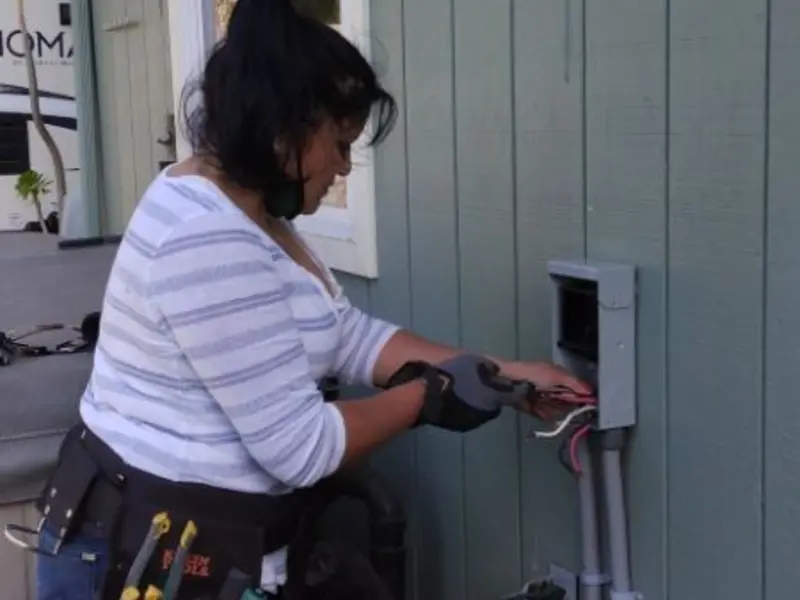 Licensed electrician wiring an exterior subpanel in Oshkosh